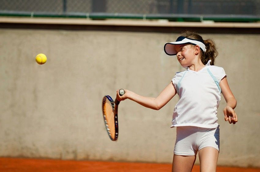 Child Playing Tennis at School Camp